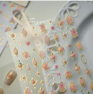 Detail of 3D embossed French nail stickers with golden frames and marble texture