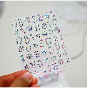 Macro detail of 3D silver star nail stickers with colorful glitter and floral patterns
