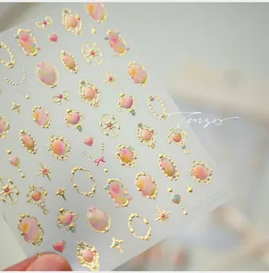 Macro shot of M-1211 French nail stickers with gold embossed frames and heart patterns