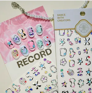 Close-up of sweet star and floral nail art stickers with silver edges and glitter finish