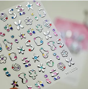 Detailed view of silver 3D nail art stickers with star and floral designs, model M-1223