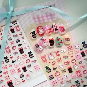 Detail showing 3D cartoon rabbit and cherry nail art stickers applied on pink nails