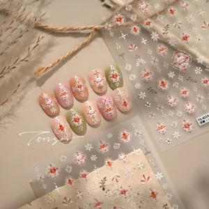 Detailed macro of 5D embossed Christmas nail stickers with snowman and snowflake designs