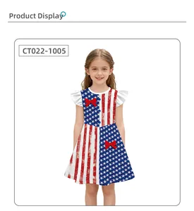 Detail of girls' dress showing stars and stripes print with red bows and ruffled sleeves