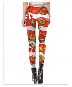Detail of Christmas leggings featuring festive prints of socks and bells with black boots