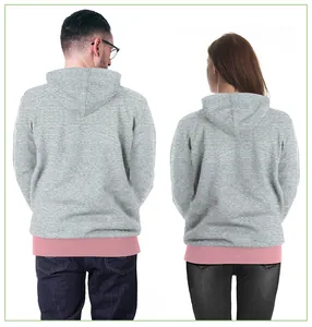 Rear view of couple wearing gray hoodies with pink trim and festive deer digital print
