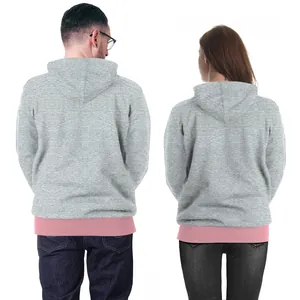 Matching Christmas deer print hoodies for couples in grey with stylish pink layered look