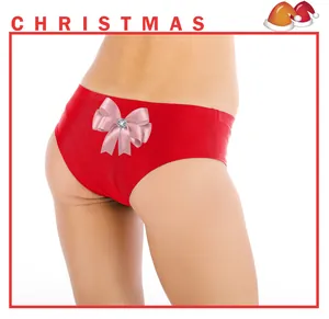 Detail of red Christmas panties featuring a pink satin bow and sparkling rhinestone