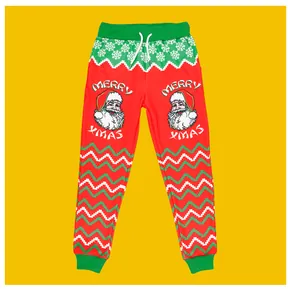 Detail of red Christmas jogger pants with Santa Claus print and green ribbed cuffs