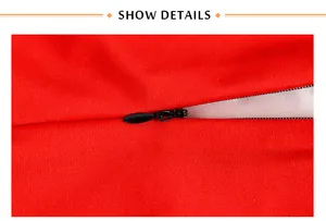 Détail d'une fermeture éclair noire invisible sur un tissu rouge à texture tissée serrée