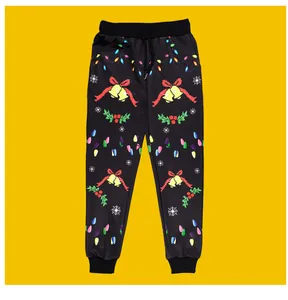 Dettaglio dei pantaloni sportivi neri per bambini con motivi festivi di campane e fiocchi