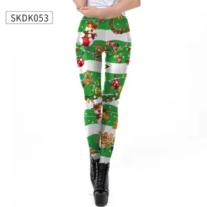 Detail shot of Christmas leggings with festive prints on green and white striped fabric