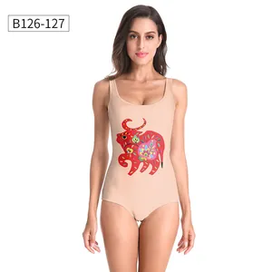 Detailed front view of nude one-piece swimsuit featuring a colorful folk art cow print