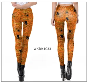 Detail of Halloween leggings with orange stripes, black spider webs, and spiders pattern