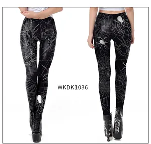 Detailed view of high elastic black leggings featuring white spider and web pattern prints