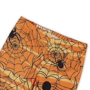 Halloween orange striped leggings for girls featuring black spider and web print patterns