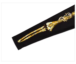 Detail of black elastic dress with luxury gold skeleton and gemstone print textures