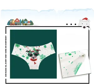 Detail of Christmas panty featuring puppy digital print and festive green snowflake motifs