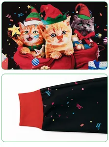 Detailed close-up of festive 3D Christmas cats print and red ribbed cuffs on sweatshirt