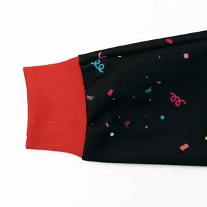 Kids Christmas sweatshirt featuring red ribbed cuffs and colorful confetti party print