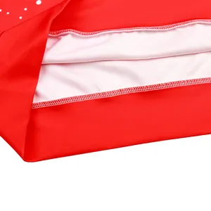 Close-up of red polka dot Christmas sweatshirt with double-needle hem stitching detail