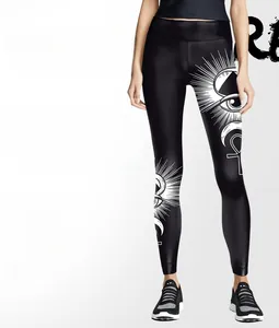 Detail of occult Ouija style white eye and Ankh print on black high-waist yoga leggings