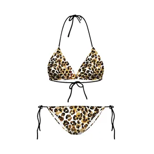 Detailed flat lay of a leopard print bikini set with black strings on white background