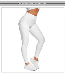 Detail of white high-waisted yoga leggings with textured honeycomb fabric on legs
