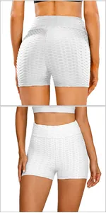 Detail view of high waist white yoga shorts with honeycomb textured fabric and slim fit