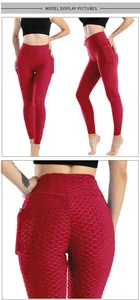 Dettaglio dei leggings rossi a nido d'ape con vita alta e tasca laterale per telefono