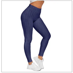 Macro shot of dark blue scrunch butt yoga leggings featuring textured honeycomb fabric