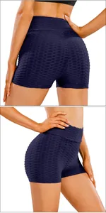 Detail of high-waisted scrunch butt yoga shorts with honeycomb textured fabric in navy blue