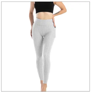 Dettaglio dei leggings fitness a vita alta con trama a nido d'ape da donna grigio chiaro