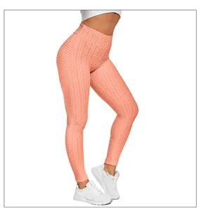 Close-up of coral pink high waisted yoga leggings with textured honeycomb bubble fabric