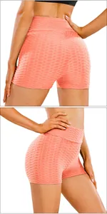 Detail of coral pink honeycomb textured high-waisted yoga shorts for women
