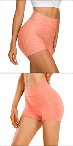 Macro detail of honeycomb texture and peach lifting design on coral pink yoga shorts
