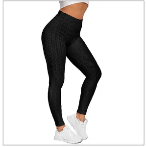 Close-up of black high-waisted yoga leggings with honeycomb texture and push-up effect