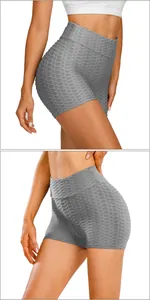 Close-up of gray high-waist yoga shorts with textured honeycomb fabric and ruched detail