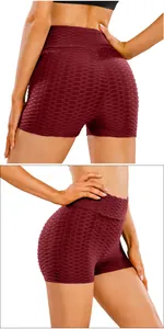 Detail of high waist burgundy yoga shorts showing honeycomb texture and scrunch butt lifting effect