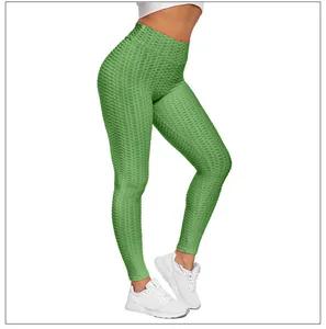 Detail showing high-waisted green yoga pants with textured honeycomb fabric and push-up seam
