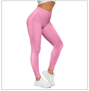 Close-up of pink high-waist yoga leggings with honeycomb texture and push-up effect
