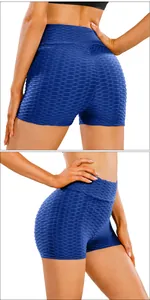 Detail of high-waisted navy blue yoga shorts with scrunch butt honeycomb texture