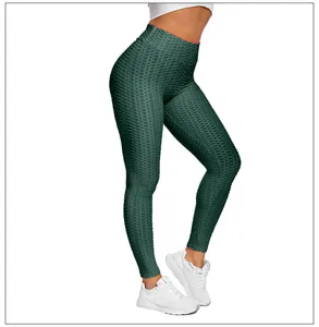 Detail showing high-waisted dark green honeycomb textured yoga leggings for women
