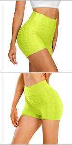 Close-up of textured honeycomb fabric on high-waist fluorescent yellow yoga shorts