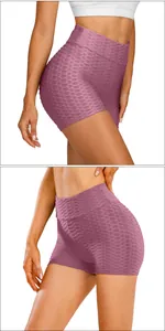 Detail of high-waisted pink yoga shorts showing honeycomb texture and peach lift design