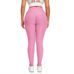 Pink high waist scrunch butt honeycomb leggings for women in a professional gym pose