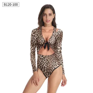 Detail of leopard print long sleeve swimsuit with cutout bust and black bow tie decoration