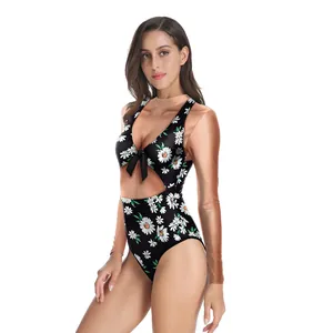 Detail of floral one-piece swimsuit with V-neck bow and side waist cut-out