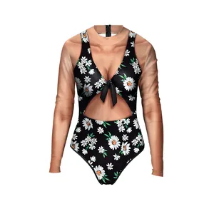 Close-up of one-piece swimsuit featuring daisy floral print and bow tie front detail