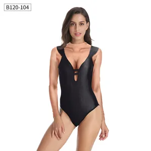 Detail of sexy deep V-neckline on black one-piece swimsuit with decorative straps
